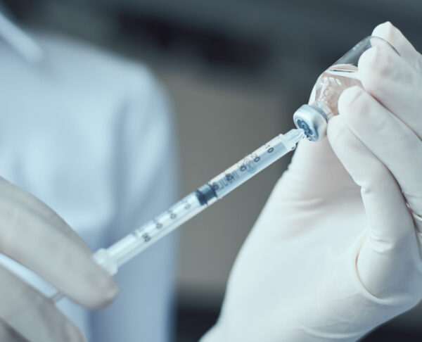 Woman hold injection syringe and medicine vial ampoule.  Healthc